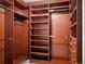 Spacious walk-in closet with custom wood shelving and drawers, offering ample storage space at 1891 Curtis St # 1820, Denver, CO 80202