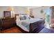 Comfortable main bedroom with hardwood floors, large bed, and an abundance of natural light at 130 N Pearl St # 1804, Denver, CO 80203