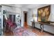 Hallway with hardwood floors, area rug, and large wall mirror at 130 N Pearl St # 1804, Denver, CO 80203