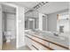 Bright bathroom featuring a double sink vanity with a large mirror and modern fixtures at 1888 S Jackson St # 604, Denver, CO 80210