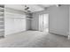 Spacious bedroom featuring a ceiling fan, soft carpet, closet, and sliding glass door at 1888 S Jackson St # 604, Denver, CO 80210