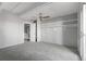 A well-lit bedroom with a ceiling fan, carpet flooring, and a closet visible through an open door at 1888 S Jackson St # 604, Denver, CO 80210