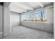 Spacious room with carpet flooring, a large window, and bright light at 1888 S Jackson St # 604, Denver, CO 80210