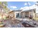 Inviting backyard patio with a wooden fence, a charming rock garden, and stylish string lights overhead at 721 Forest View Rd, Monument, CO 80132
