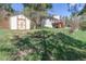 Backyard with a storage shed next to the house showing a wooden deck and lush greenery at 721 Forest View Rd, Monument, CO 80132