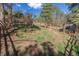 Expansive backyard with trees and a wooden fence offers privacy and a natural setting at 721 Forest View Rd, Monument, CO 80132