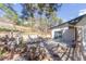 Landscaped backyard with a patio, wooden bridge, and charming stone features at 721 Forest View Rd, Monument, CO 80132