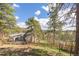 Scenic backyard shows a house with a deck, a lawn, and trees, blending living with nature at 721 Forest View Rd, Monument, CO 80132