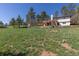 Expansive backyard offers ample space, a wooden deck, and a tranquil setting with mature trees at 721 Forest View Rd, Monument, CO 80132