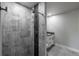 Modern bathroom featuring sleek gray tile shower with niche, modern vanity, and stylish fixtures at 721 Forest View Rd, Monument, CO 80132