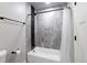 Modern bathroom features a soaking tub with stylish gray and black tile surround and neutral walls at 721 Forest View Rd, Monument, CO 80132