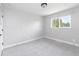 Simple bedroom featuring new carpet, neutral decor, bright window, and ample natural light at 721 Forest View Rd, Monument, CO 80132