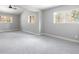 Bright bedroom with neutral walls, plush carpet, and large windows offering pleasant outdoor views at 721 Forest View Rd, Monument, CO 80132