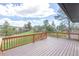 Well-maintained wood deck with railings and scenic backyard views at 721 Forest View Rd, Monument, CO 80132