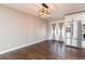 Dining room area with hardwood floors, stainless fridge, and large window at 721 Forest View Rd, Monument, CO 80132