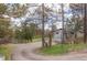 Scenic driveway winding towards a home with a two-car garage and wooded surroundings at 721 Forest View Rd, Monument, CO 80132