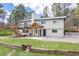 Charming two-story home featuring a wooden deck, inviting entryway, and lush green lawn at 721 Forest View Rd, Monument, CO 80132