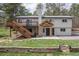Charming two-story home featuring a wooden deck, inviting entryway, and lush green lawn at 721 Forest View Rd, Monument, CO 80132