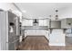 Modern kitchen featuring white cabinets, stainless steel appliances, and dark hardwood floors at 721 Forest View Rd, Monument, CO 80132