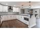 Modern kitchen featuring white cabinets, stainless steel appliances, and dark hardwood floors at 721 Forest View Rd, Monument, CO 80132