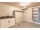 Spacious laundry room features a sink, ample cabinetry, washer/dryer hookups, and storage shelving at 721 Forest View Rd, Monument, CO 80132