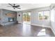 Bright living room with stone fireplace and access to an outdoor deck at 721 Forest View Rd, Monument, CO 80132