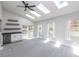 Sunlit living room features skylights, a wet bar, and access to a patio at 721 Forest View Rd, Monument, CO 80132
