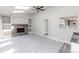 Cozy living room with fireplace, built-in shelving, and pass-through to kitchen at 721 Forest View Rd, Monument, CO 80132