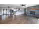 Open-concept living room features modern kitchen, hardwood floors, and stone fireplace at 721 Forest View Rd, Monument, CO 80132