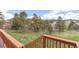 Wooden deck overlooks a tranquil yard featuring grass and mature trees at 721 Forest View Rd, Monument, CO 80132