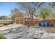 Backyard with a garden and detached garage with lawn area, providing space for gardening at 8801 W 65Th Ave, Arvada, CO 80004