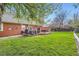 Lush backyard with a well-maintained lawn and outdoor seating on the deck at 8801 W 65Th Ave, Arvada, CO 80004