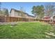 Fenced backyard with green lawn and landscaping features an inviting outdoor dining area at 8801 W 65Th Ave, Arvada, CO 80004