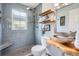 Bathroom featuring gray tile and a wood vanity with vessel sink at 8801 W 65Th Ave, Arvada, CO 80004