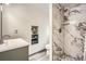 Bathroom featuring stand up shower with gray tile and built-in shelving at 8801 W 65Th Ave, Arvada, CO 80004
