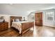 Bedroom featuring hardwood floors, light gray walls and wood furnishings at 8801 W 65Th Ave, Arvada, CO 80004