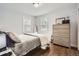 Bedroom with two windows and light gray walls. Features hardwood floors and light neutral decor at 8801 W 65Th Ave, Arvada, CO 80004