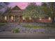 Charming single-Gathering home featuring a cozy front porch and colorful, well-maintained landscaping at 8801 W 65Th Ave, Arvada, CO 80004