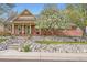 Charming single-Gathering home featuring a cozy front porch and colorful, well-maintained landscaping at 8801 W 65Th Ave, Arvada, CO 80004