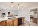 Bright kitchen with light gray walls, quartz countertops, and wood cabinets at 8801 W 65Th Ave, Arvada, CO 80004