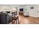 Inviting living room featuring hardwood floors, modern lighting, and comfortable seating arrangement at 8801 W 65Th Ave, Arvada, CO 80004