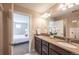 Double vanity bathroom with shower and bedroom view at 821 Robert St, Longmont, CO 80503