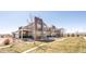 Modern townhome exteriors with manicured lawn, walkways and a seating area at 821 Robert St, Longmont, CO 80503