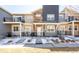 Inviting townhome features a mix of stone and gray siding, a white front door, and charming front patios at 821 Robert St, Longmont, CO 80503