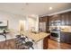 Modern kitchen with stainless steel appliances and breakfast bar at 821 Robert St, Longmont, CO 80503