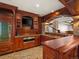 A home bar featuring custom wood cabinets, granite countertops, and brick floors at 1880 Mallard Dr, Broomfield, CO 80020