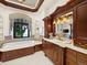 Luxurious bathroom with custom cabinetry, a soaking tub, a large window, and elegant fixtures at 1880 Mallard Dr, Broomfield, CO 80020