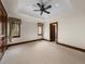 Large empty bedroom with neutral carpet, wood trim, two windows and lots of space at 1880 Mallard Dr, Broomfield, CO 80020