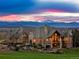 Stunning exterior elevation of a luxury home with mountain views and manicured lawn at sunset at 1880 Mallard Dr, Broomfield, CO 80020