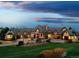 Beautiful home featuring lush lawns, manicured landscaping, and an inviting entrance at twilight at 1880 Mallard Dr, Broomfield, CO 80020